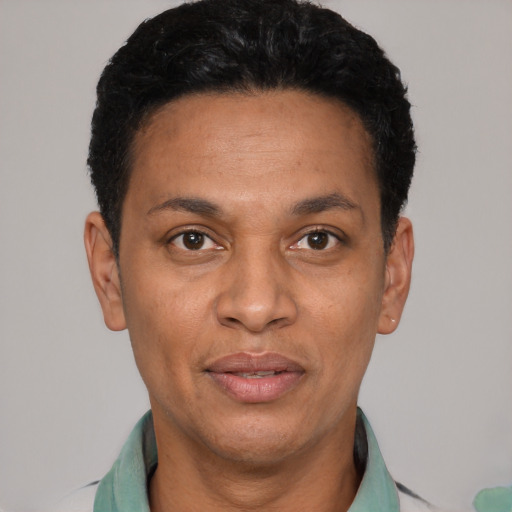 Joyful latino adult male with short  black hair and brown eyes