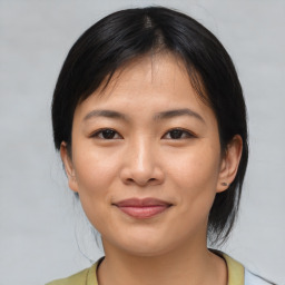 Joyful asian young-adult female with medium  black hair and brown eyes