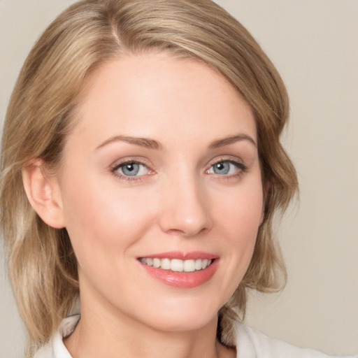 Joyful white young-adult female with medium  brown hair and blue eyes