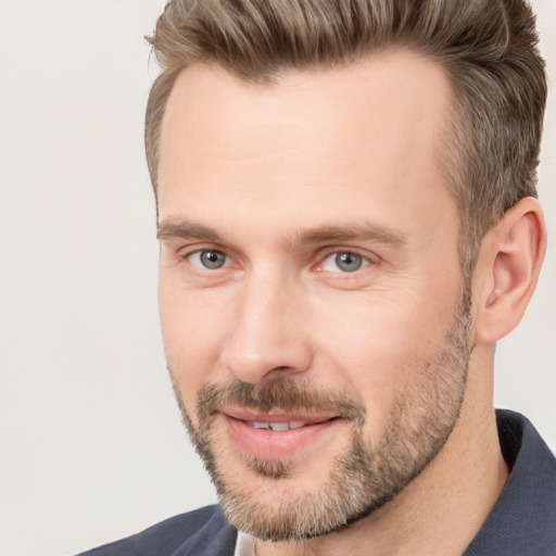 Joyful white adult male with short  brown hair and brown eyes