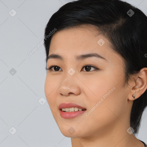 Joyful asian young-adult female with medium  black hair and brown eyes