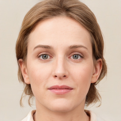 Joyful white young-adult female with medium  brown hair and blue eyes