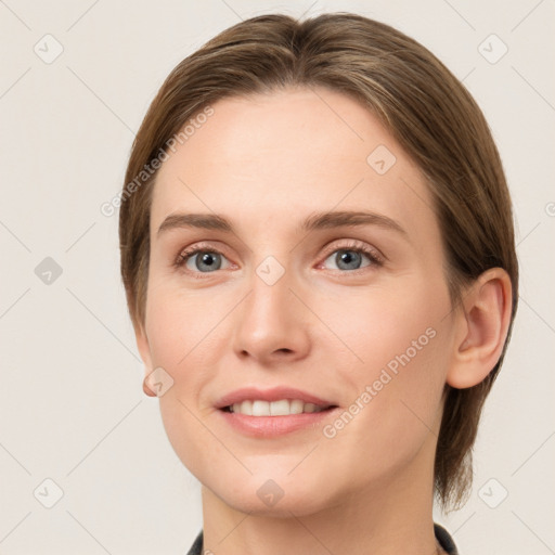 Joyful white young-adult female with medium  brown hair and grey eyes