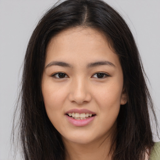 Joyful asian young-adult female with long  brown hair and brown eyes