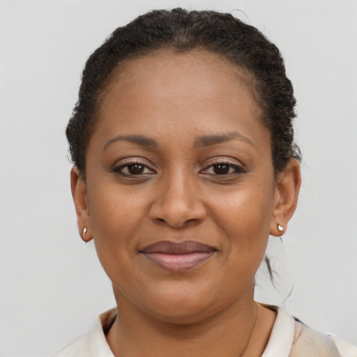 Joyful black young-adult female with short  brown hair and brown eyes