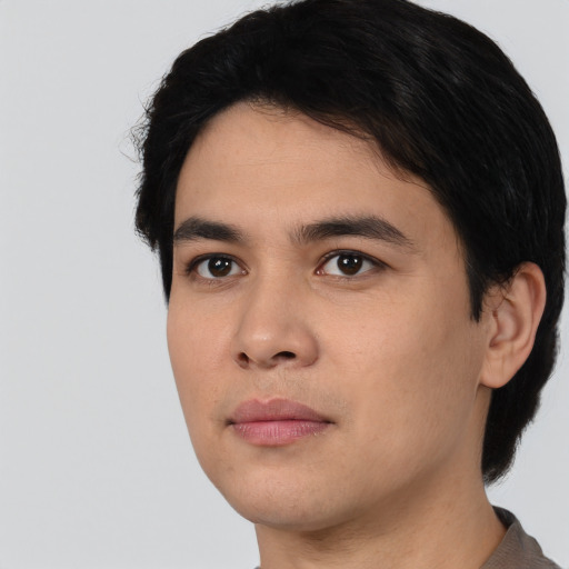 Joyful asian young-adult male with short  black hair and brown eyes