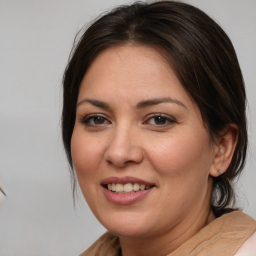 Joyful white adult female with medium  brown hair and brown eyes