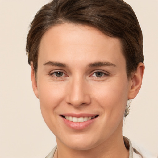 Joyful white young-adult female with short  brown hair and brown eyes