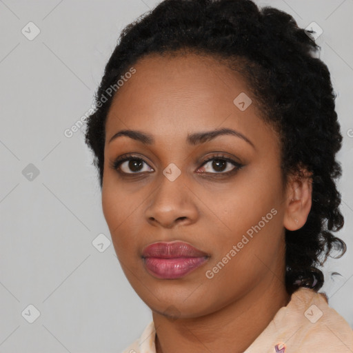 Joyful black young-adult female with long  black hair and brown eyes