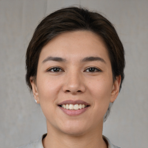 Joyful white young-adult female with medium  brown hair and brown eyes