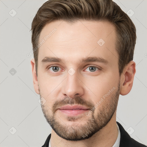 Joyful white young-adult male with short  brown hair and grey eyes