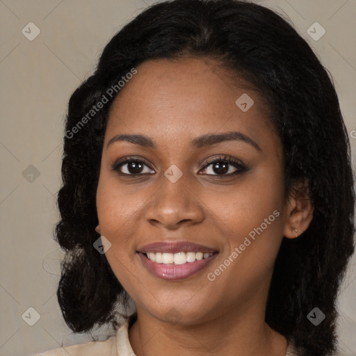 Joyful black young-adult female with long  black hair and brown eyes