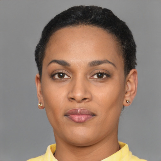 Joyful black young-adult female with short  brown hair and brown eyes