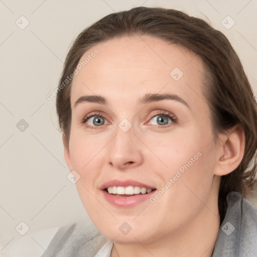 Joyful white young-adult female with medium  brown hair and grey eyes