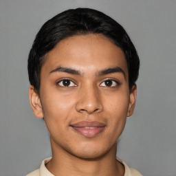 Joyful latino young-adult male with short  black hair and brown eyes