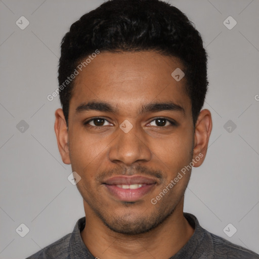 Joyful black young-adult male with short  black hair and brown eyes