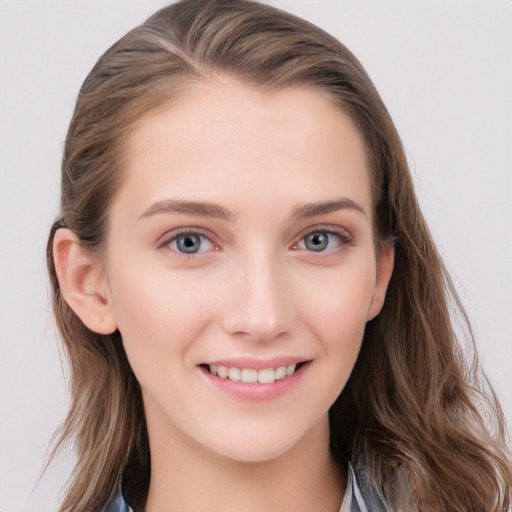 Joyful white young-adult female with long  brown hair and blue eyes