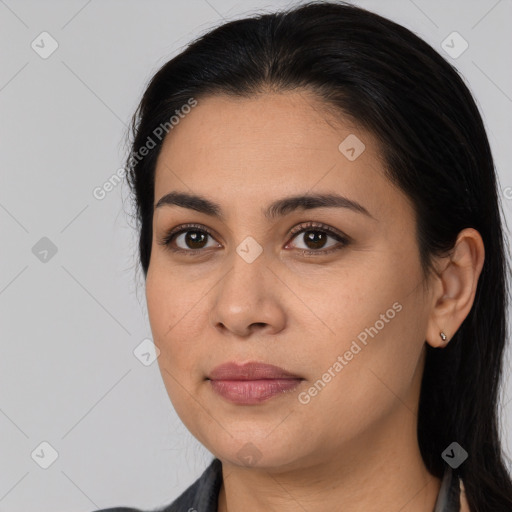 Joyful latino young-adult female with long  black hair and brown eyes