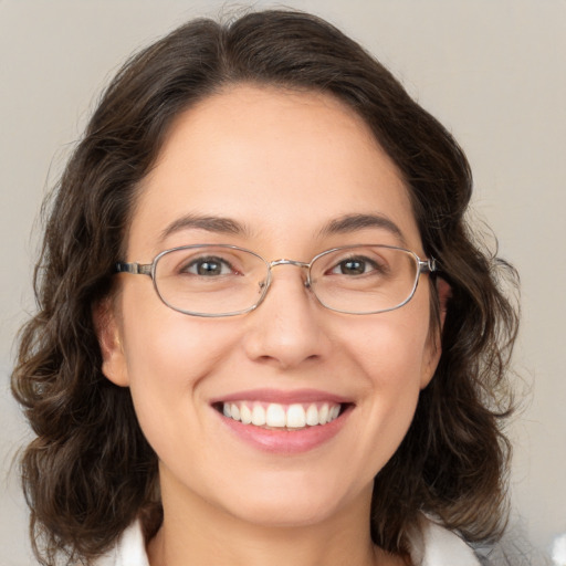 Joyful white adult female with medium  brown hair and brown eyes