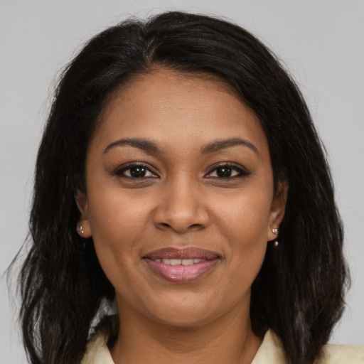 Joyful black young-adult female with medium  brown hair and brown eyes