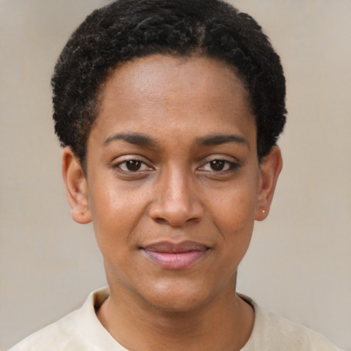Joyful black young-adult female with short  black hair and brown eyes