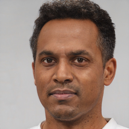 Neutral black adult male with short  black hair and brown eyes