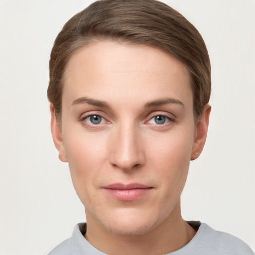 Joyful white young-adult female with short  brown hair and grey eyes