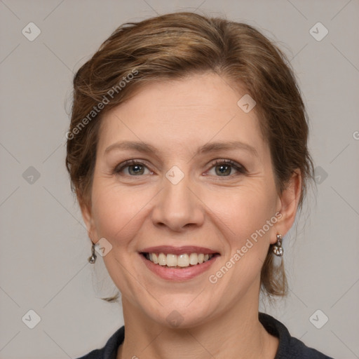 Joyful white adult female with medium  brown hair and grey eyes