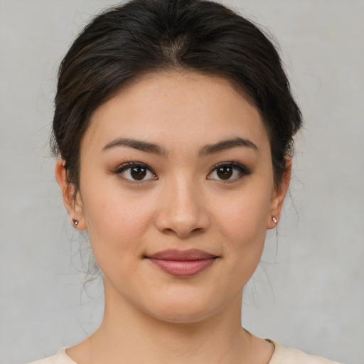 Joyful asian young-adult female with medium  brown hair and brown eyes