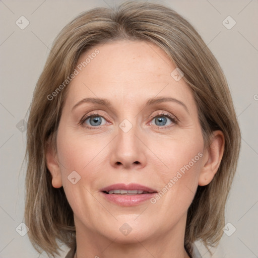 Joyful white adult female with medium  brown hair and grey eyes