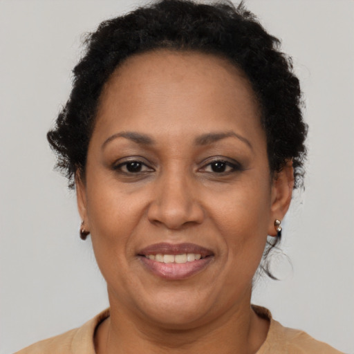 Joyful black adult female with short  brown hair and brown eyes