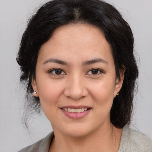 Joyful asian young-adult female with medium  brown hair and brown eyes
