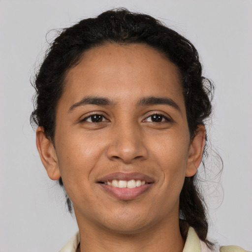 Joyful latino young-adult male with short  brown hair and brown eyes