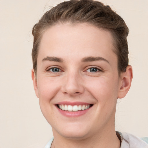 Joyful white young-adult female with short  brown hair and grey eyes