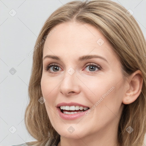 Joyful white young-adult female with long  brown hair and blue eyes