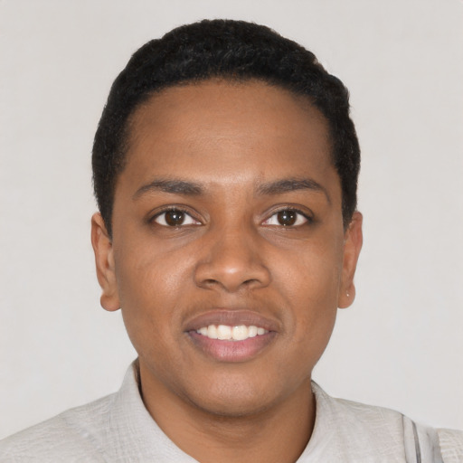 Joyful black young-adult male with short  black hair and brown eyes