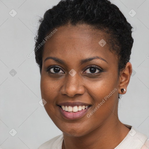 Joyful black young-adult female with short  brown hair and brown eyes