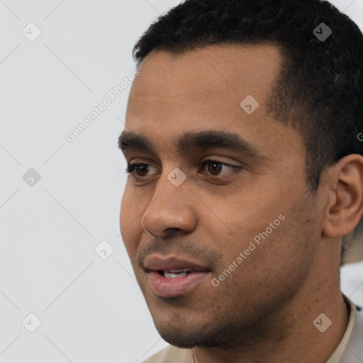 Joyful latino young-adult male with short  black hair and brown eyes