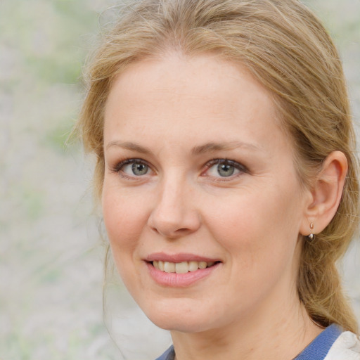 Joyful white adult female with medium  brown hair and blue eyes