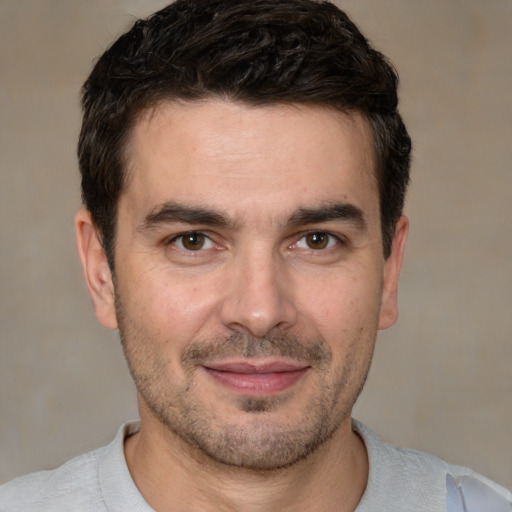 Joyful white adult male with short  brown hair and brown eyes