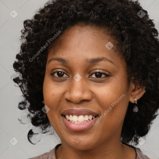 Joyful black young-adult female with long  brown hair and brown eyes