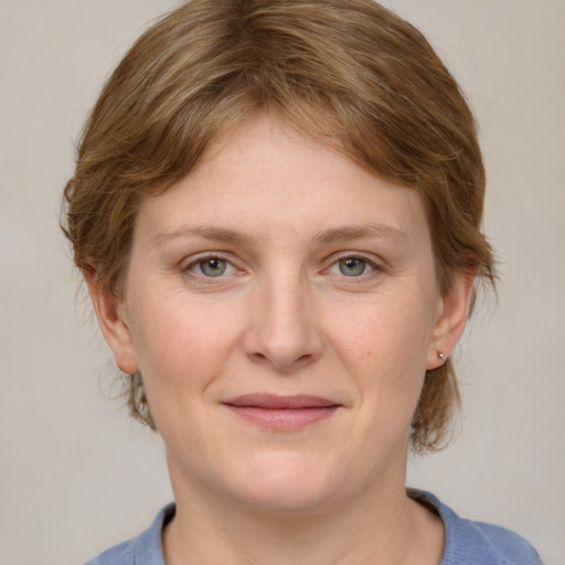 Joyful white young-adult female with medium  brown hair and blue eyes