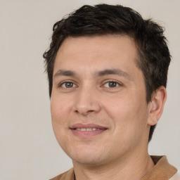 Joyful white young-adult male with short  brown hair and brown eyes