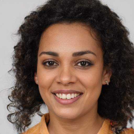 Joyful latino young-adult female with medium  brown hair and brown eyes