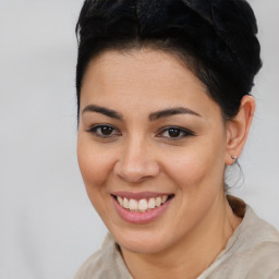 Joyful latino young-adult female with medium  brown hair and brown eyes