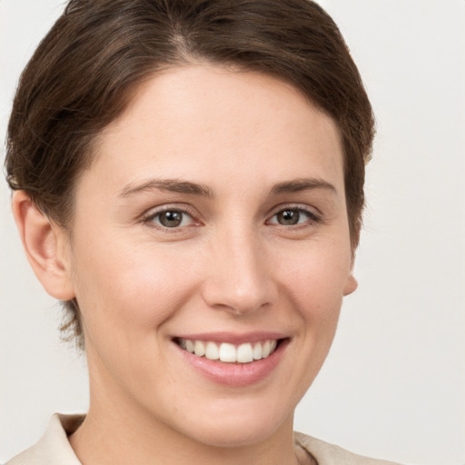 Joyful white young-adult female with short  brown hair and brown eyes