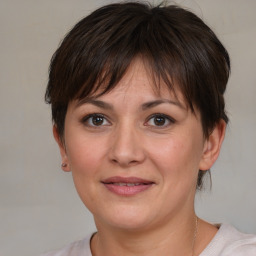 Joyful white adult female with medium  brown hair and brown eyes