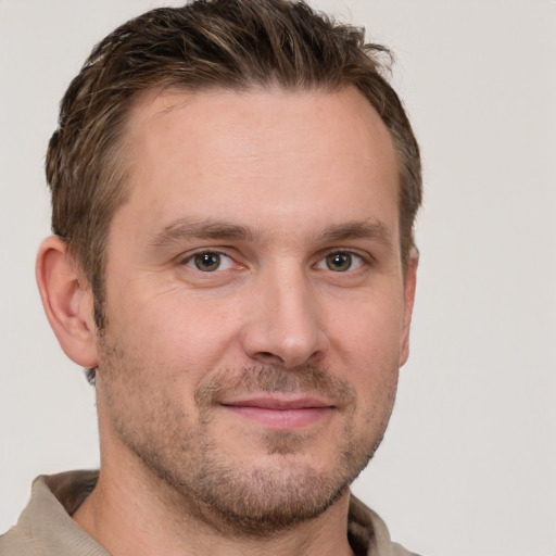 Joyful white adult male with short  brown hair and grey eyes