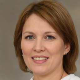 Joyful white adult female with medium  brown hair and brown eyes