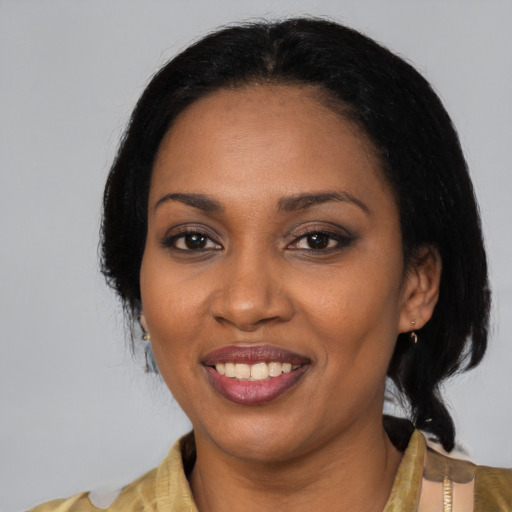Joyful black adult female with medium  black hair and brown eyes